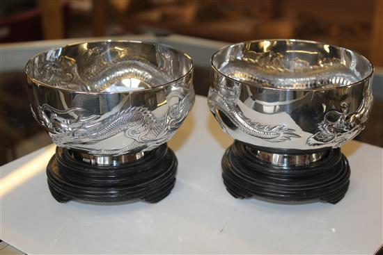 Pair of Chinese silver dragon designed bowls on stand